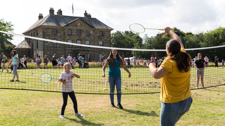 Family playing badminton at Ormesby Hall Summer of Play